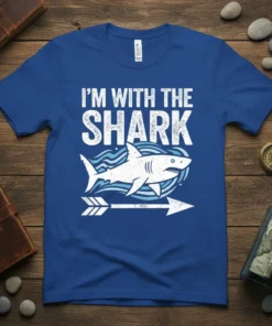 Blue t-shirt with white text "I'M WITH THE SHARK" and a graphic of a shark with waves and an arrow
