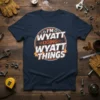 Navy t-shirt with white and orange text reading "I'M WYATT DOING WYATT THINGS" in a circular graphic