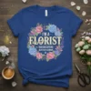 I'm a Florist I Run on Caffeine Glitter & Chaos quote on a blue t-shirt surrounded by a floral wreath