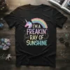 Black t-shirt with "I'm A Freakin' Ray Of Sunshine" text, a unicorn, and a rainbow graphic