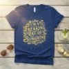 I'm A Freaking Ray Of Sunshine quote in decorative gold lettering on a navy blue t-shirt