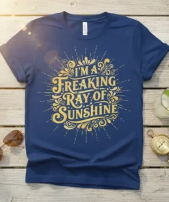 I'm A Freaking Ray Of Sunshine quote in decorative gold lettering on a navy blue t-shirt