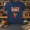 I'm a Little Chili text above a cute cartoon chili pepper wearing a scarf on a navy blue t-shirt