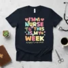 I'm A Nurse & This Is My Week quote with colorful letters and medical symbols on a navy t-shirt