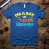 I'm A Ray Of Fucking Sunshine bold typography graphic t-shirt design in yellow, orange, and blue with lightning bolt accents