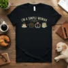 I'm a Simple Woman t-shirt design with icons for coffee, paw print, wine glass, and books