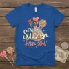 I'm A Sucker For You text design with colorful lollipops and candy in a jar on a blue t-shirt