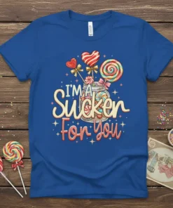 I'm A Sucker For You text design with colorful lollipops and candy in a jar on a blue t-shirt