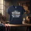 Navy t-shirt with white and gold text that reads "I'M A VETERAN NOT A SUCKER OR A LOSER"