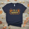 Navy blue t-shirt with "I'm A Warrior RSD/CRPS Awareness" text, orange ribbon, and monarch butterflies