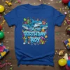 I'm The Birthday Boy text with cartoon sharks wearing party hats and surrounded by gifts, on a blue t-shirt