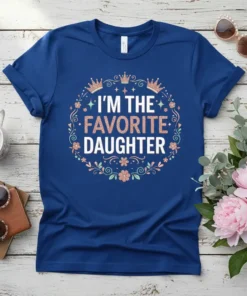 I'm The Favorite Daughter quote on a navy blue t-shirt, surrounded by a floral wreath and crowns