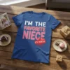Blue t-shirt with white and pink text that reads "I'M THE FAVORITE NIECE IT'S OFFICIAL" in a fun font