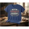 T-shirt with "I'm The Favorite Parent" text in vintage distressed font, surrounded by laurel wreath and stars