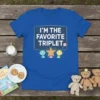 Blue t-shirt with white text "I'm the Favorite Triplet" and cute cartoon triplets graphic