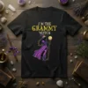 I'm the Grammy Witch text with a witch graphic on a black t-shirt