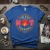I'm The Hot Grandma text design with a fiery heart graphic, surrounded by ornate gold detailing on a blue t-shirt
