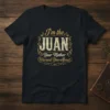 I'm the JUAN Your Mother Warned You About text design on a black t-shirt, featuring vintage-style typography and decorative borders