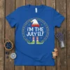 Royal blue t-shirt with "I'm The July Elf" text, elf hat, striped socks, and green elf shoes, surrounded by runes