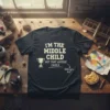I'm The Middle Child Not That Anyone Cares funny quote t-shirt with a trophy graphic and 'Sibling's Art' text