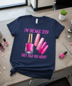 T-shirt with pink text "I'm the Nail Tech They Told You About" and graphics of nail polish bottle and nails