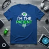 I'm The Patient t-shirt with a white brain graphic and green text, featuring a caduceus symbol