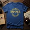 Blue t-shirt with gold text and shield graphic that reads "IMPEACH."