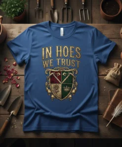 Gardening humor t-shirt with "In Hoes We Trust" text and a crest featuring garden tools, a rose, and a crown