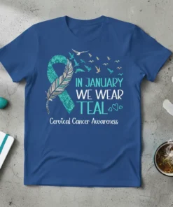 T-shirt with text "In January We Wear Teal Cervical Cancer Awareness" and a teal ribbon with a feather and flying