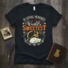 In Loving Memories Of The World's Sweetest Cat text design with sleeping cat graphic on a black t-shirt