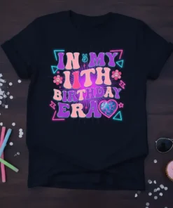 In My 11th Birthday Era text in groovy font with disco heart and retro graphics on a black t-shirt