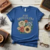 In My Abuelita Era text with a colorful bouquet of flowers on a royal blue t-shirt, floral graphic design