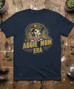 In My Aggie Mom Era t-shirt featuring a cartoon cowgirl with a cowboy hat and cowboy boots, with text "IN