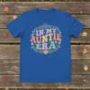 In My Auntie Era text design with floral wreath on a royal blue t-shirt