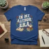In My Author Era text with open book and coffee cup graphic on a blue t-shirt