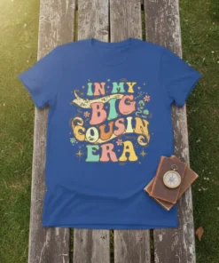 Retro style t-shirt with colorful text "In My Big Cousin Era" and decorative elements, featuring a big cousin quote