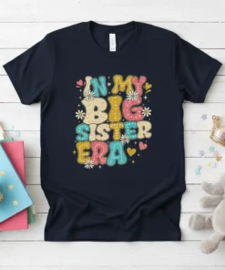 In My Big Sister Era text design with colorful retro lettering and floral accents on a navy t-shirt
