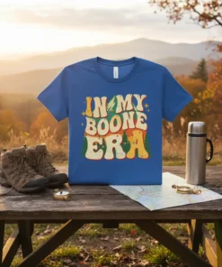 Retro "In My Boone Era" text design with mountains and trees on a blue t-shirt