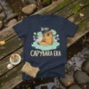 In My Capybara Era text with a cute capybara wearing sunglasses in water, on a navy t-shirt