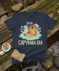 In My Capybara Era text with a cute capybara wearing sunglasses in water, on a navy t-shirt