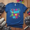 In My Cheer Aunt Era text with wings and smiley face graphic on a blue t-shirt
