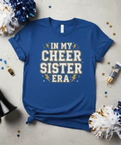In My Cheer Sister Era text design with glitter accents and lightning bolts on a royal blue t-shirt