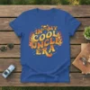 In My Cool Uncle Era text design with flames and skull graphic on a blue t-shirt