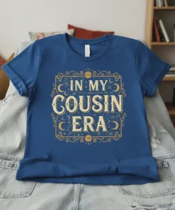 Blue t-shirt with gold text "In My Cousin Era" in a vintage, celestial design