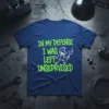 In My Defense I Was Left Unseprised text and stick figure graphic on a navy blue t-shirt