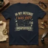 T-shirt with the full quote "In My Defense I Was Left Unsupervised" and graphics of paw prints, beakers, and books