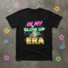 Black t-shirt with neon text "IN MY GLOW UP ERA" and a colorful geometric gem graphic