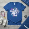 In My Gymnastics Mom Era text with graphic elements and silhouettes of gymnasts on a blue t-shirt