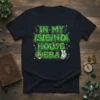 T-shirt with "In My Isibindi House Era" text in green bubble letters, featuring a lion head and peace sign graphic