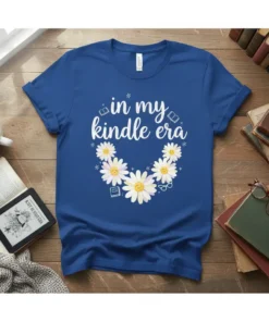 White text "in my kindle era" with daisy graphics on a blue t-shirt, featuring books and glasses icons